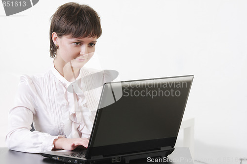 Image of Young businesswoman looking to monitor
