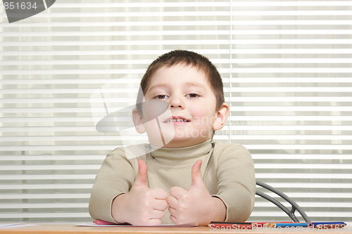 Image of Smiling boy showing both thumbs up
