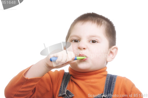 Image of Boy brushing teeth with effort