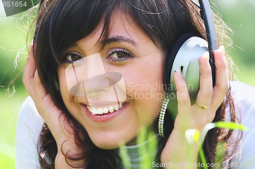 Image of Smiling brunette with headphones