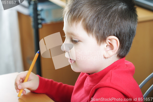 Image of Boy in red with pen