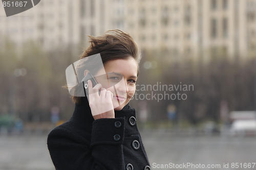 Image of Businesswoman with cellphone in city