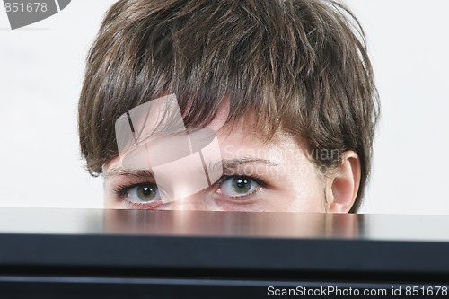 Image of Woman hiding behind desk