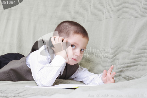 Image of Little boy with cellphone and book