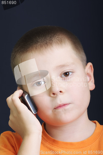 Image of Serious boy in orange with cellphone