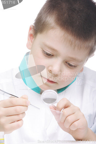 Image of Boy examining object through magnifier