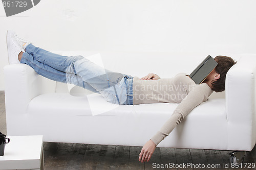 Image of Afternoon nap with book on face