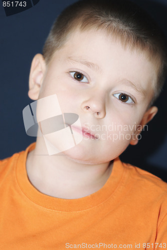 Image of Boy in orange bending head