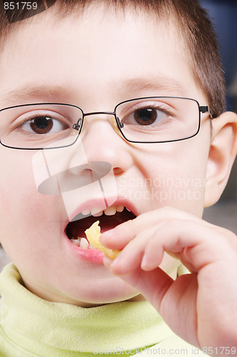 Image of Boy eats potato