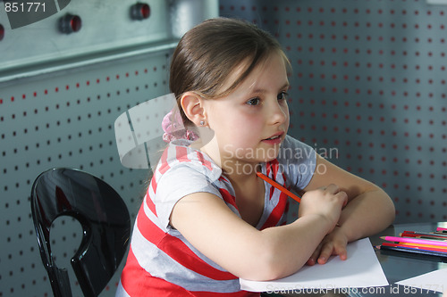 Image of Little girl with pencils and paper