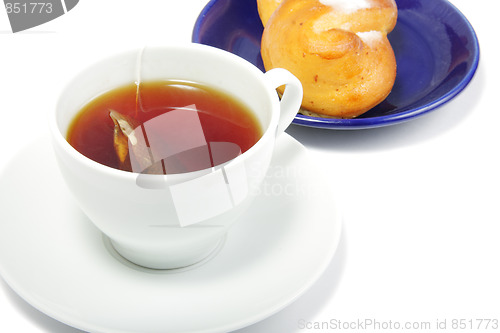 Image of Tea and bun in blue saucer