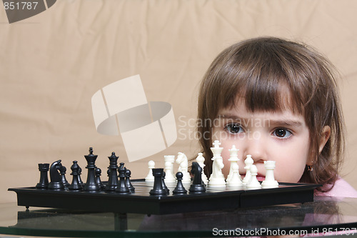 Image of Girl considering chess position