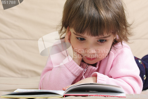 Image of Little girl in pink reading