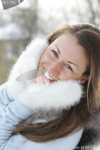 Image of Smiling woman in white mittens