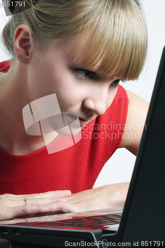 Image of Woman in red looking to monitor