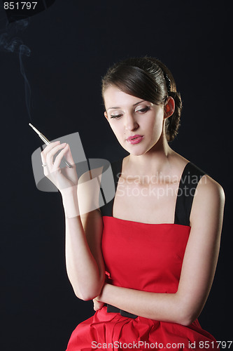 Image of Thoughtful woman in red smoking