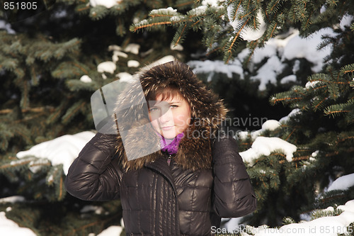 Image of Brunette under big fir tree