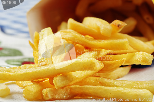 Image of French fries scattered on table