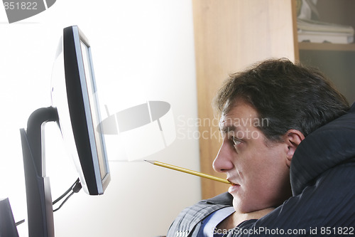 Image of Businessman with pencil in teeth