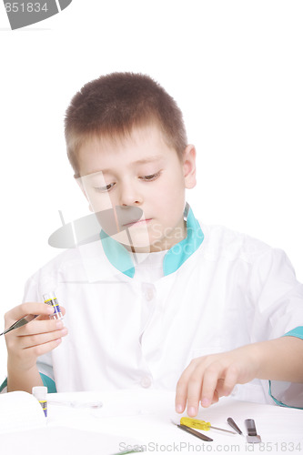 Image of Boy and lab tools on desk