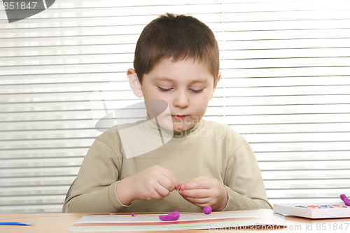 Image of Boy modelling with plasticine