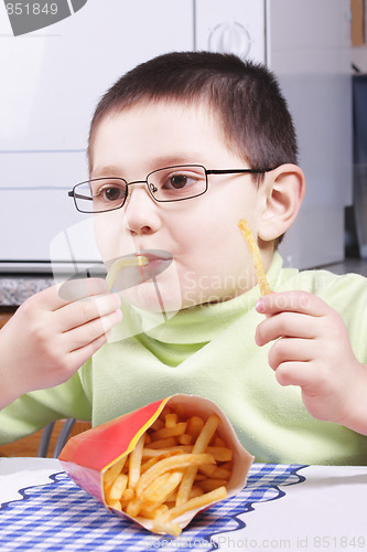 Image of Boy eating fried potato
