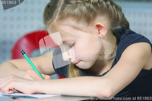 Image of Little girl drawing with pencil