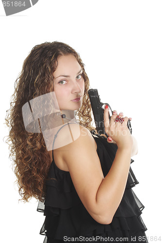 Image of Serious woman with gun looking over shoulder