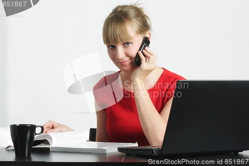 Image of Smiling businesswoman with cellphone and magazine