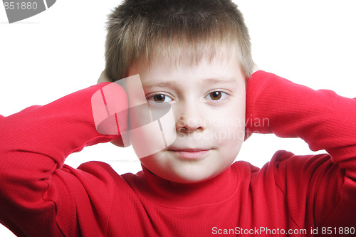 Image of Boy in red shutting ears