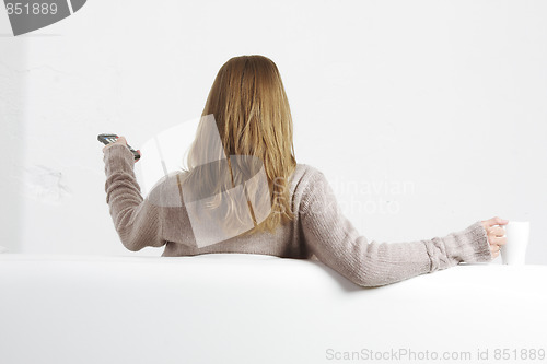 Image of Blonde with remote control rear view