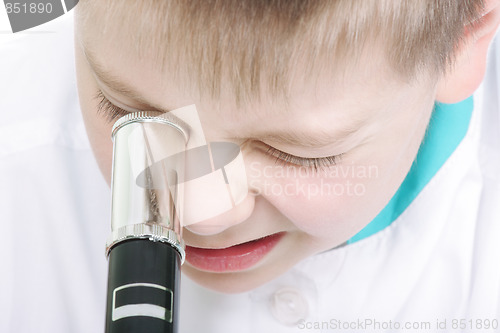 Image of Kid with microscope closeup