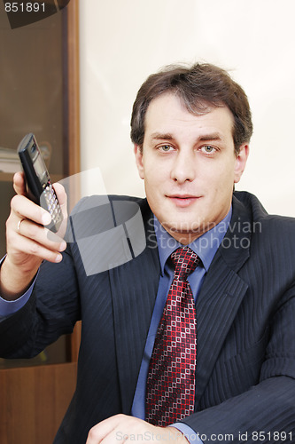 Image of Businessman giving phone