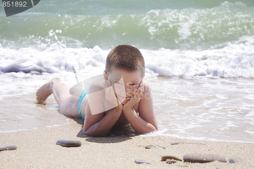 Image of Kid laying on beach