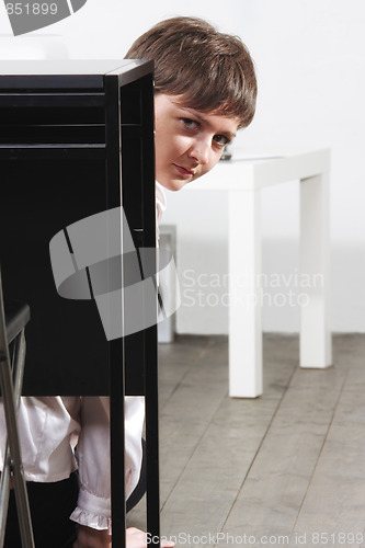 Image of Businesswoman hiding behind desk