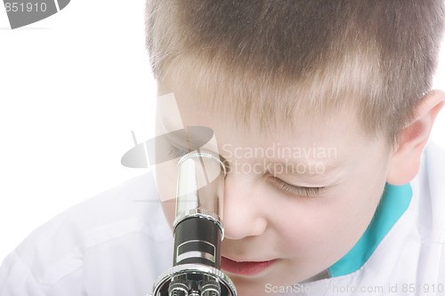 Image of Kid looking into microscope closeup