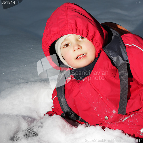 Image of Boy laying in snow