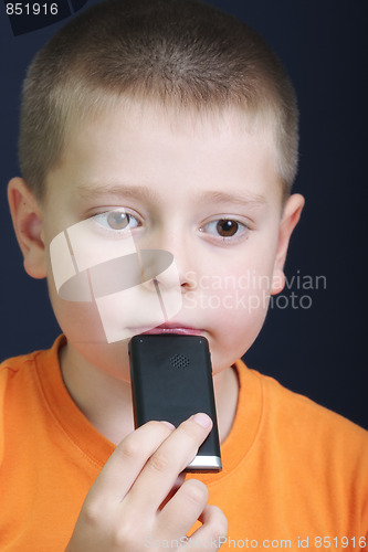 Image of Thoughtful kid in orange with cellphone