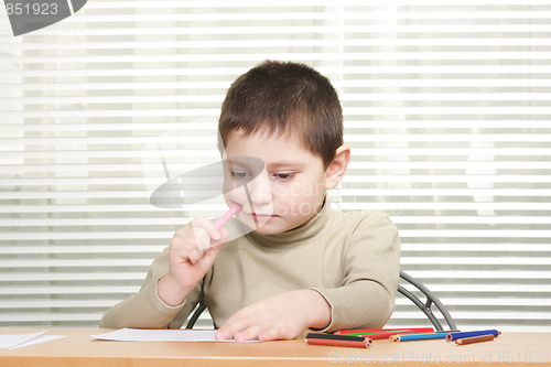Image of Boy with pencils and paper