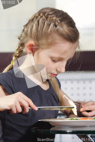 Image of Girl eating fried eggs