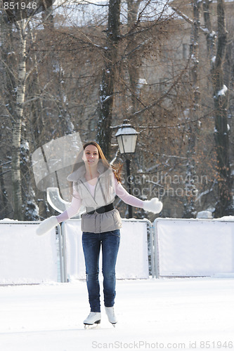Image of Ice-skating brunette woman