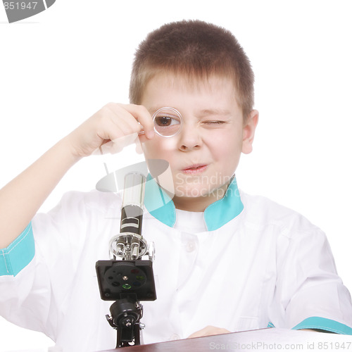 Image of Boy looking to magnifying glass
