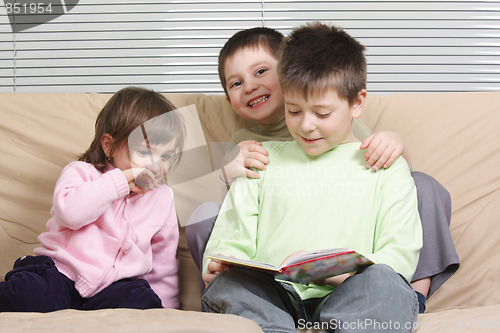 Image of Three children reading book