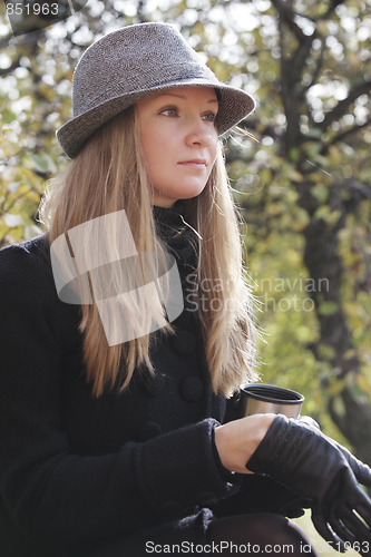 Image of Woman in black coat wearing on glove