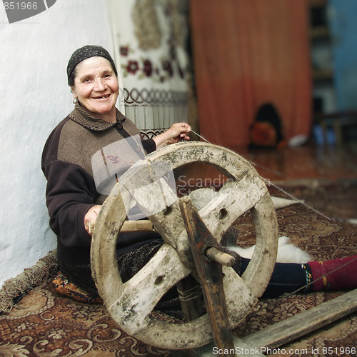 Image of Smiling senior working on loom