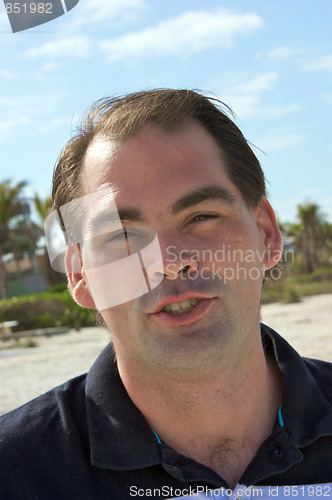 Image of average guy on beach talking