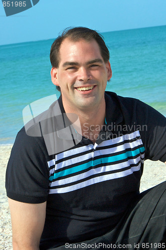 Image of friendly smiling man at beach