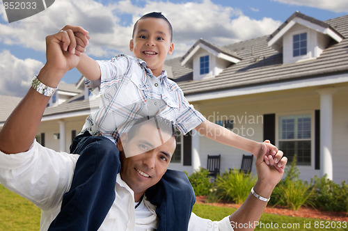 Image of Hispanic Father and Son in Front of House