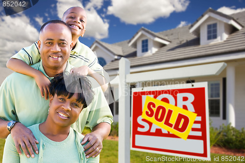 Image of African American Family with Sold For Sale Sign and House