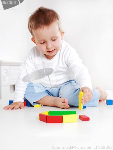 Image of Lovely boy playing with blocks